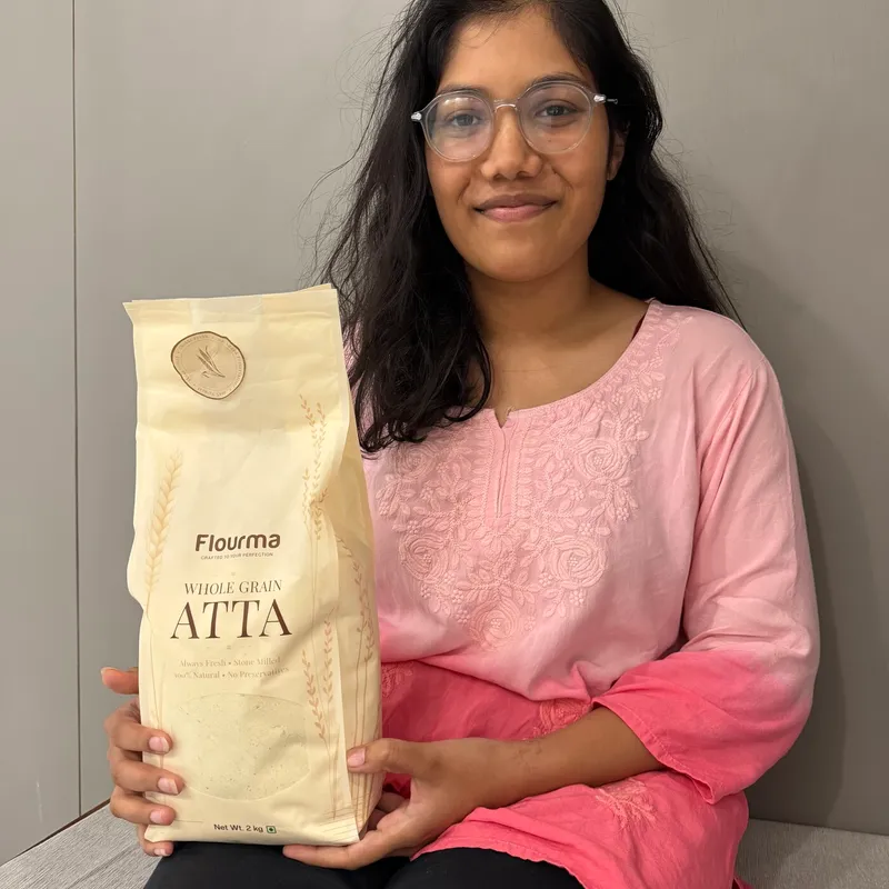 Garima J. holding a pack of Flourma Gut Calm Gluten-Free