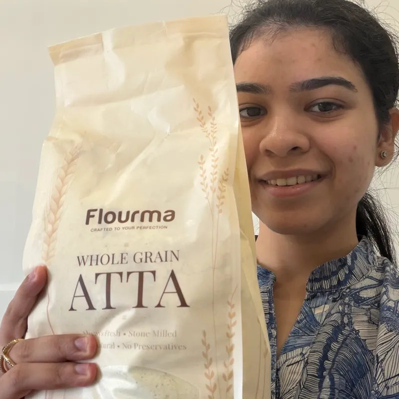 Radhika S. holding a pack of Flourma Everyday Sharbati+